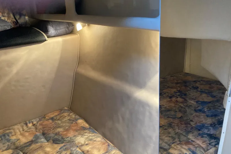 Slide: The Image of 1999 Chaparral Signature 29 cabin interior with cozy sleeping area and soft lighting. - 39