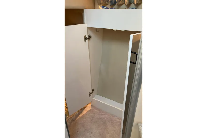 Slide: The Image of Open cabinet inside 1999 Chaparral Signature 29 boat, showcasing interior storage space. - 40