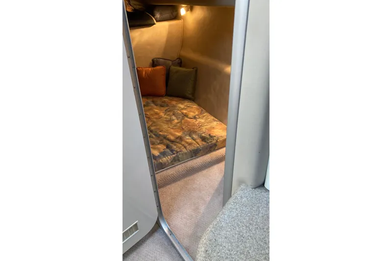 Slide: The Image of Cozy cabin interior of 1999 Chaparral Signature 29 with cushions and soft lighting. - 42