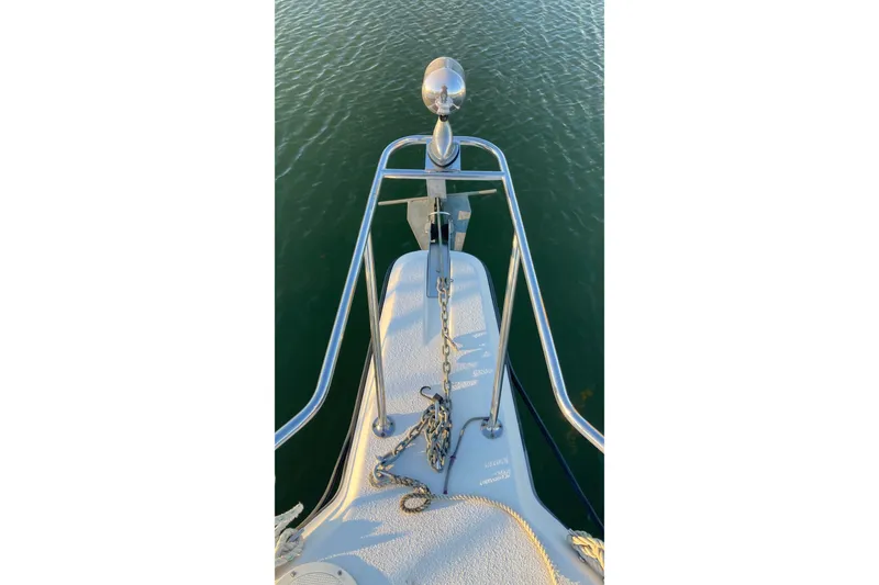 Slide: The Image of Bow of 1999 Chaparral Signature 29 boat with anchor chain over water. - 45