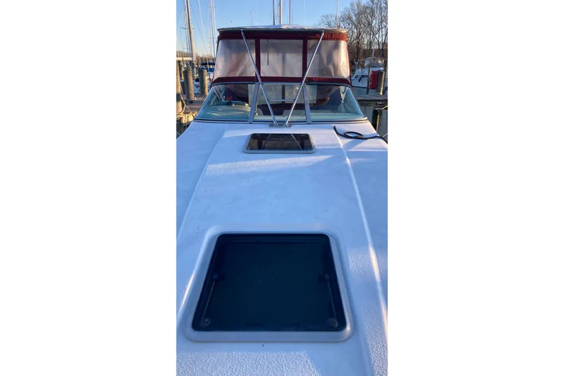 Slide: The Image of 1999 Chaparral Signature 29 boat with red canopy, docked at marina. - 46