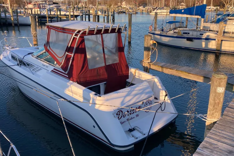 Slide: The Image of 1999 Chaparral Signature 29 boat docked in a marina with red canopy. - 49