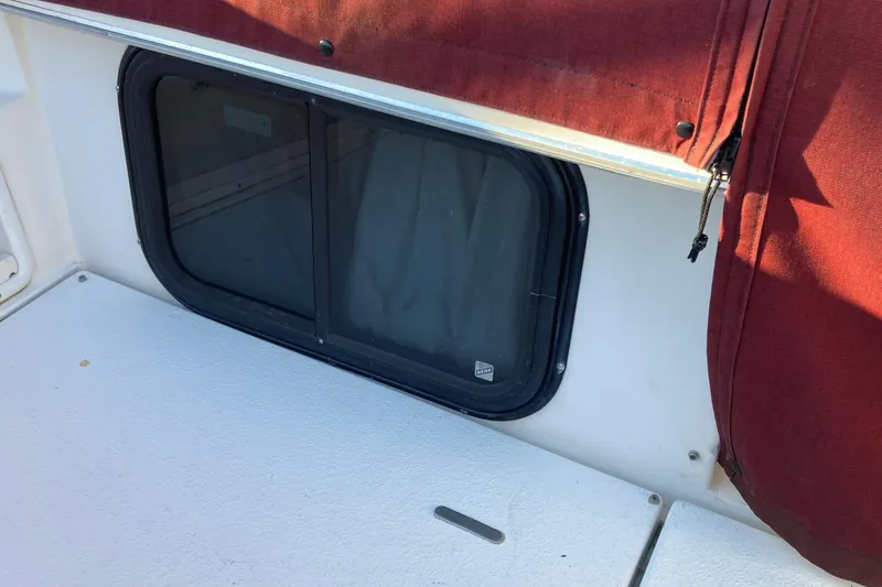 Slide: The Image of 1999 Chaparral Signature 29 boat window with red canvas cover. - 8