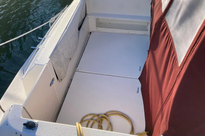 Slide: The Image of 1999 Chaparral Signature 29 boat deck with maroon canopy and coiled yellow rope. - 9