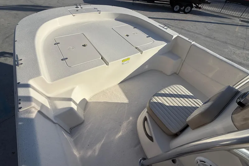 Slide: The Image of 2017 Carolina Skiff 218 boat interior with seating and storage compartments. - 10