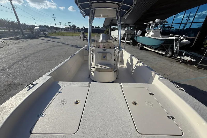 Slide: The Image of 2017 Carolina Skiff 218 boat interior with console and storage compartments. - 11