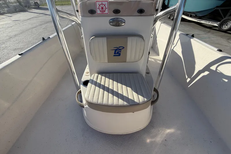 Slide: The Image of 2017 Carolina Skiff 218 boat interior with cushioned seating and metal railings. - 12