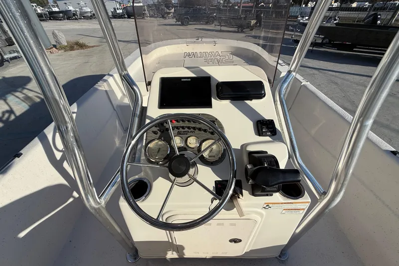 Slide: The Image of 2017 Carolina Skiff 218 boat console with steering wheel and navigation equipment. - 17