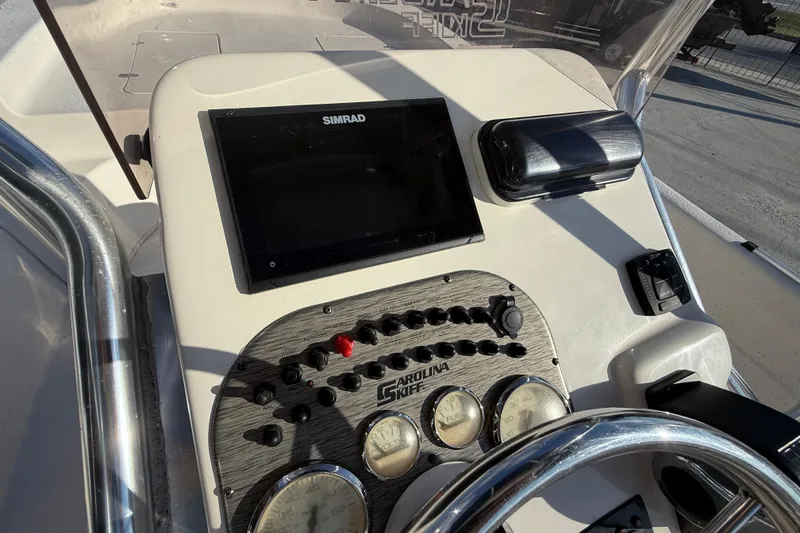 Slide: The Image of Control panel of a 2017 Carolina Skiff 218 boat with Simrad display. - 18