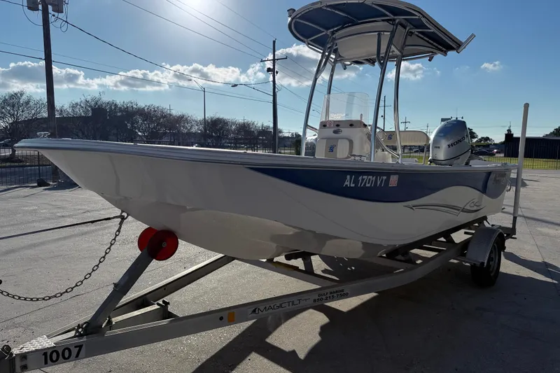 Slide: The Image of 2017 Carolina Skiff 218 boat on trailer, sunny day, Honda outboard motor. - 4