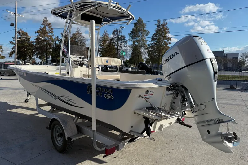 Slide: The Image of 2017 Carolina Skiff 218 boat with Honda outboard motor on trailer. - 5