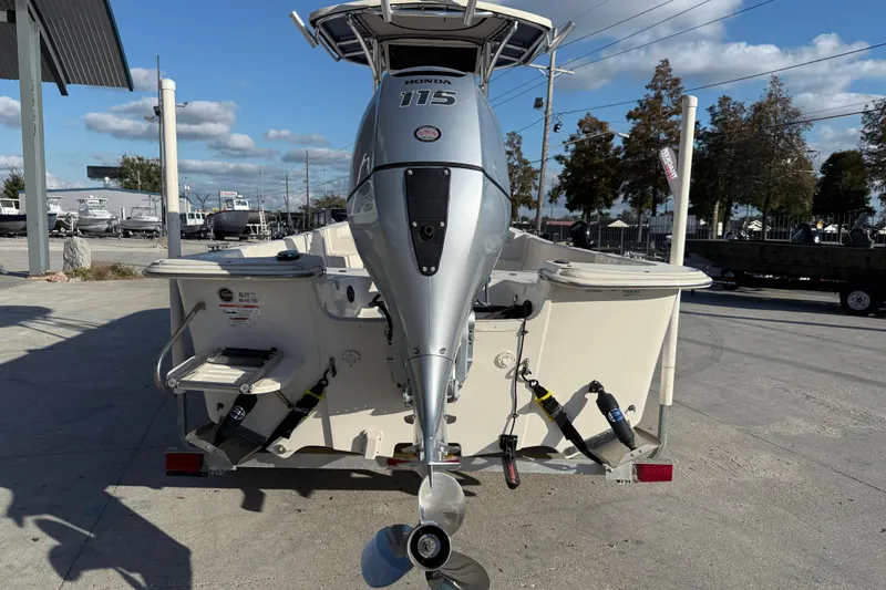 Slide: The Image of 2017 Carolina Skiff 218 boat with Honda 115 outboard motor, parked outdoors. - 6