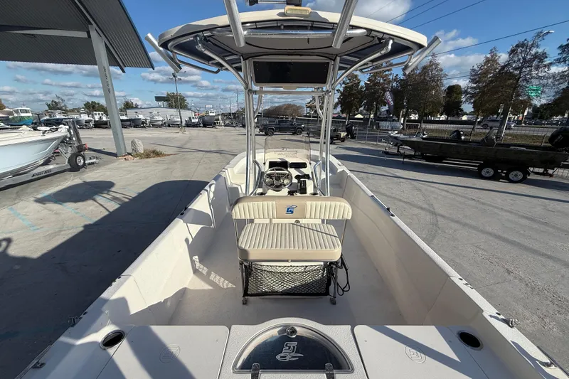 Slide: The Image of 2017 Carolina Skiff 218 boat at a dealership, showcasing interior and seating. - 8