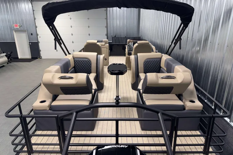 Slide: The Image of 2026 Sylvan L3 LZ pontoon boat with luxurious seating and modern design in a showroom. - 19
