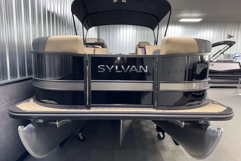 Slide: The Image of 2026 Sylvan L3 LZ pontoon boat in showroom, featuring sleek black design and comfortable seating. - 21
