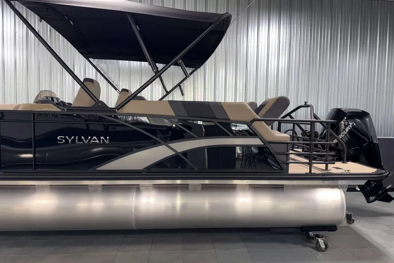 Slide: The Image of 2026 Sylvan L3 LZ pontoon boat with canopy in a showroom setting. - 25