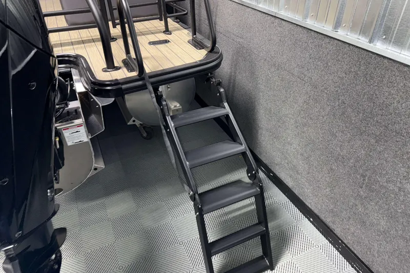 Slide: The Image of 2026 Sylvan L3 LZ boat with black ladder and wooden deck. - 27