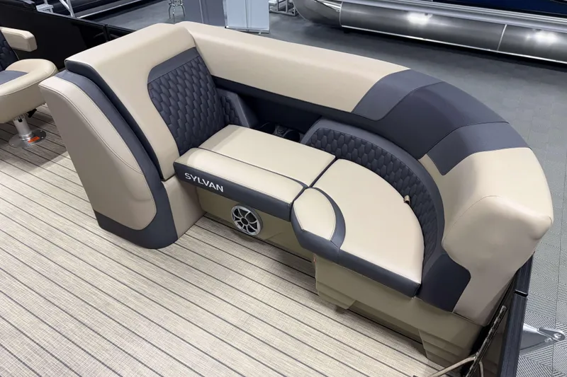 Slide: The Image of 2026 Sylvan L3 LZ boat interior with beige and gray seating, featuring a built-in speaker. - 3