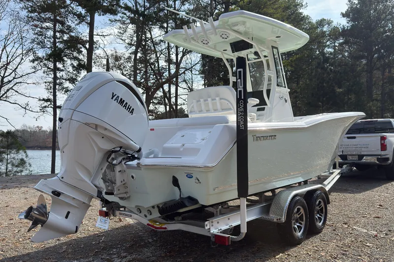 Slide: The Image of 2026 Tidewater 232 LXF boat with Yamaha engine on trailer, parked near a lake. - 2