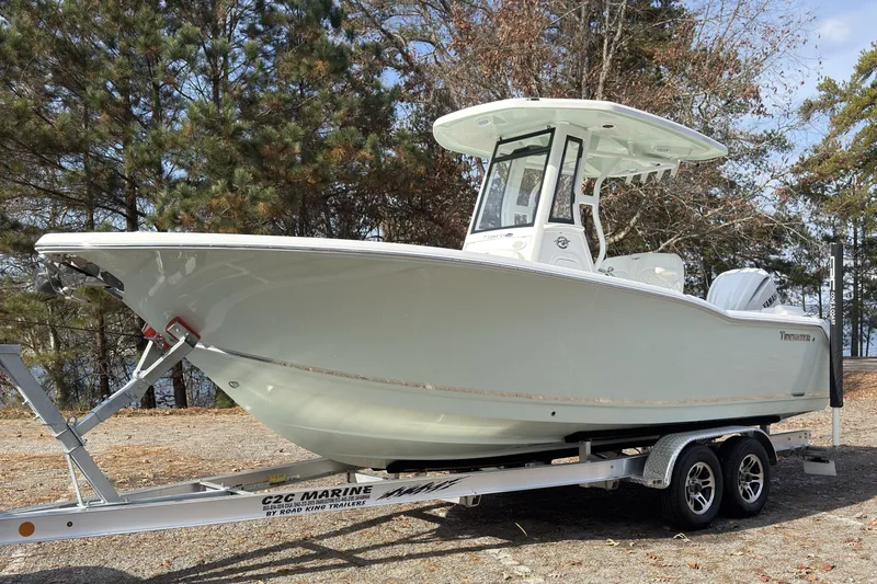 Slide: The Image of 2026 Tidewater 232 LXF boat on trailer, surrounded by trees. - 6