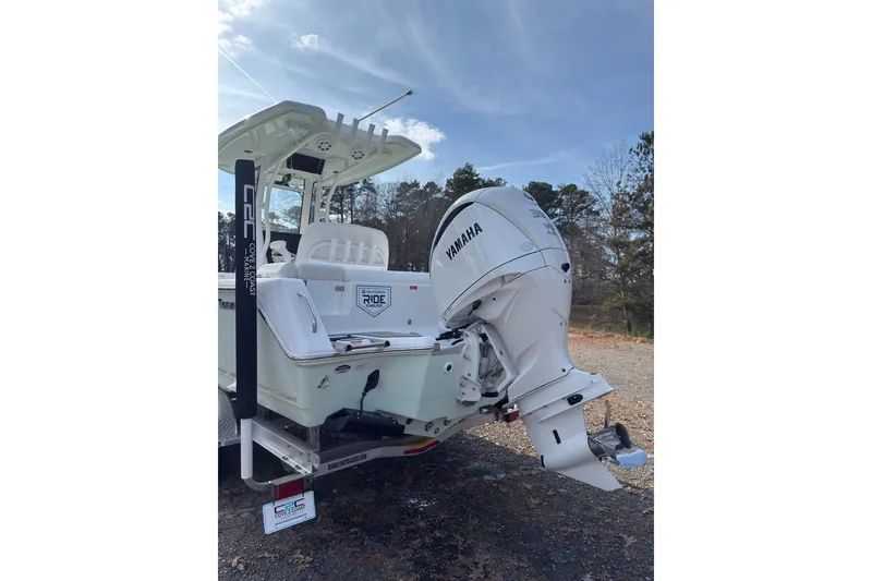 Slide: The Image of 2026 Tidewater 232 LXF boat with Yamaha outboard motor, parked outdoors. - 7