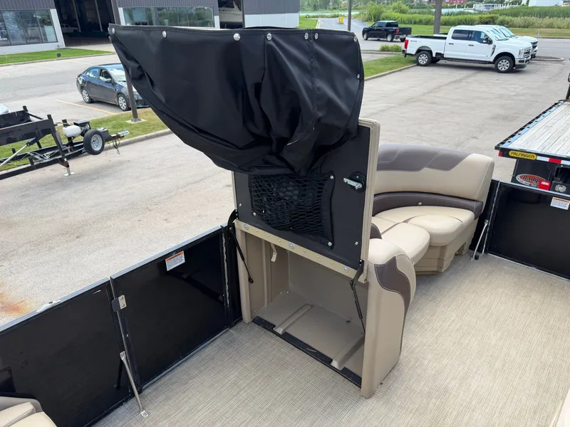Slide: The Image of The image shows the interior of a 2022 Sylvan L1 DLZTT boat with beige seating. - 25