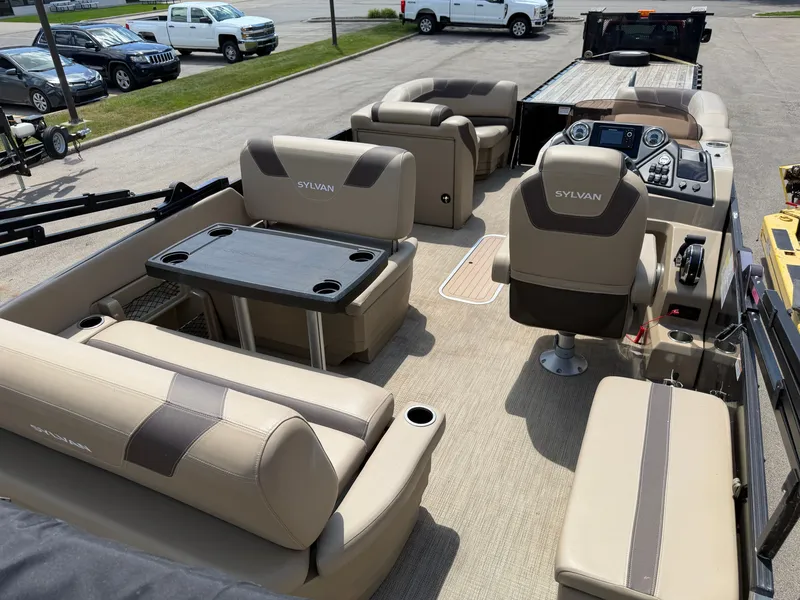 Slide: The Image of The image shows the interior of a 2022 Sylvan L1 DLZTT pontoon boat with beige seating. - 15