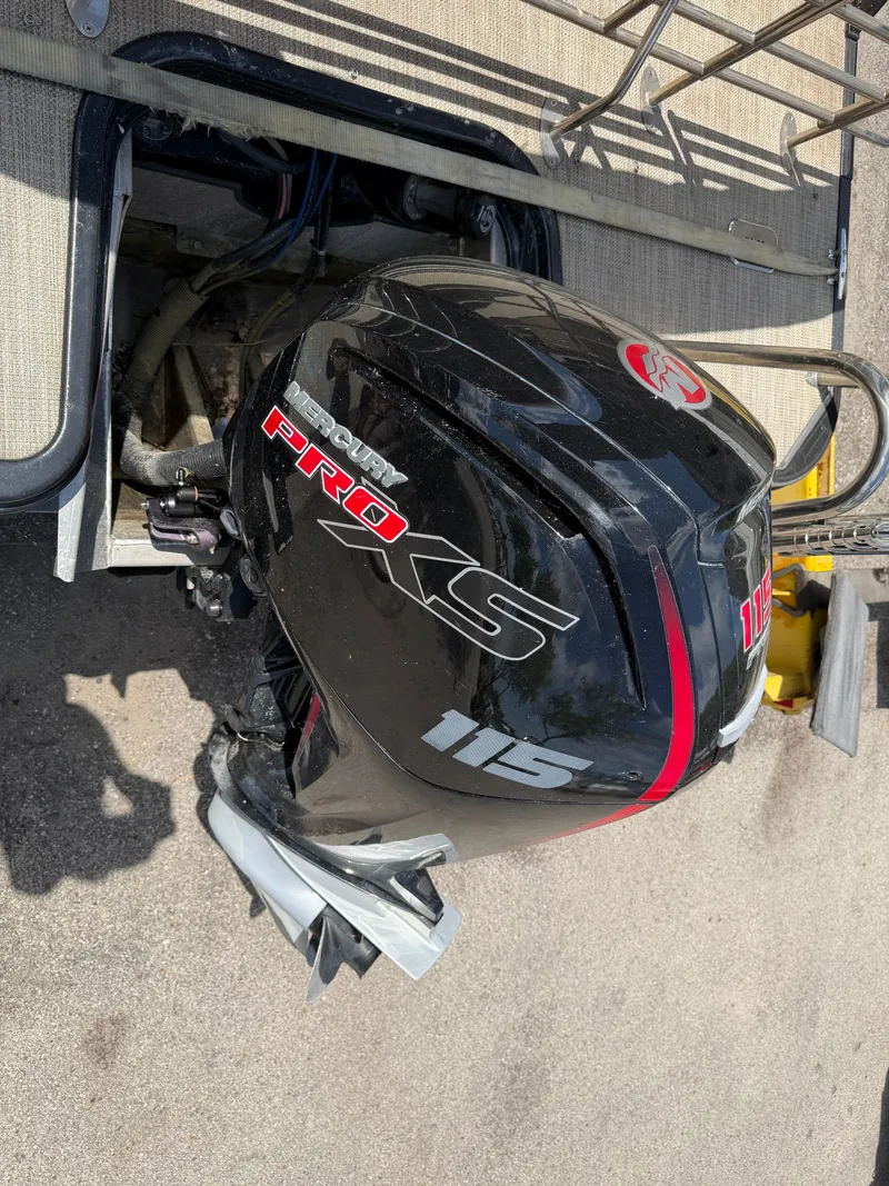 Slide: The Image of A black outboard motor labeled "Pro XS 115" is mounted on a boat. - 32