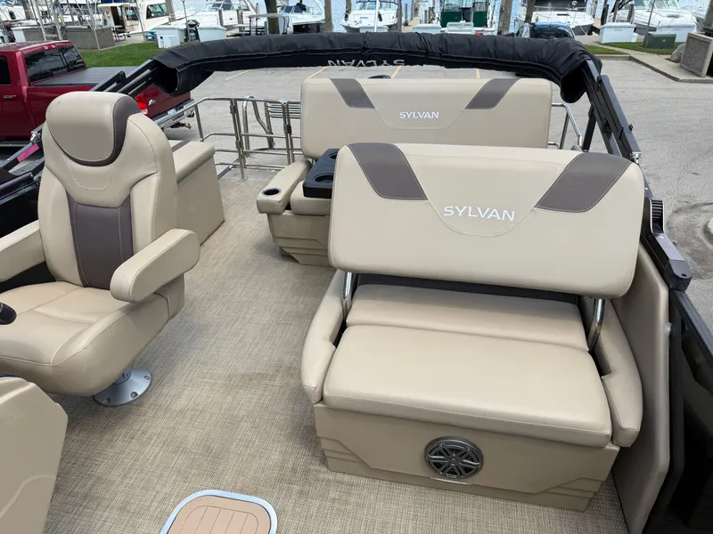 Slide: The Image of The image shows the interior of a 2022 Sylvan L1 DLZTT boat with beige seating. - 14