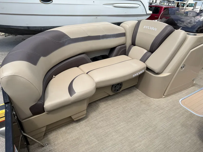 Slide: The Image of The image shows a beige and brown seating area on a Sylvan boat. - 11