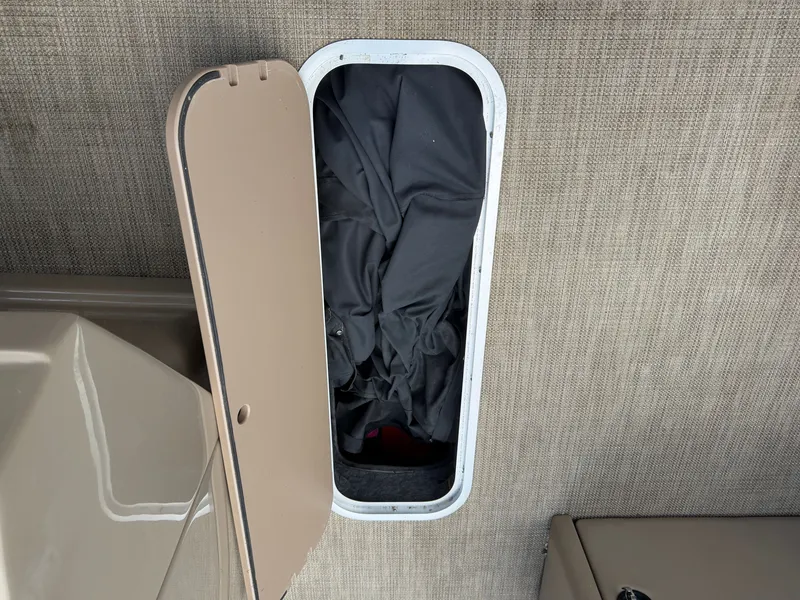 Slide: The Image of An open storage compartment with fabrics inside on a boat. - 26