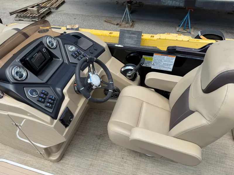 Slide: The Image of The image shows the cockpit of a 2022 Sylvan L1 DLZTT boat with beige seating and control console. - 18