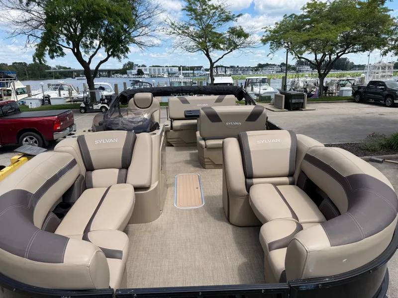 Slide: The Image of The image shows a 2022 Sylvan L1 DLZTT pontoon boat with luxurious seating and an open deck. - 10