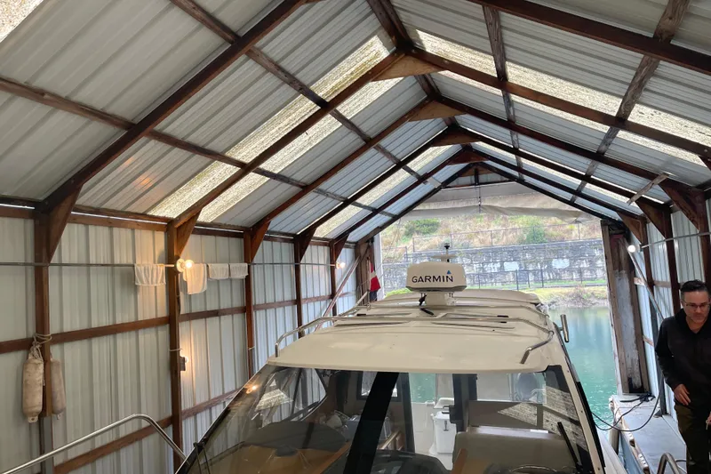 Slide: The Image of Interior of 2016 Cutwater C-24 boat with wooden table and cushioned seating. - 13