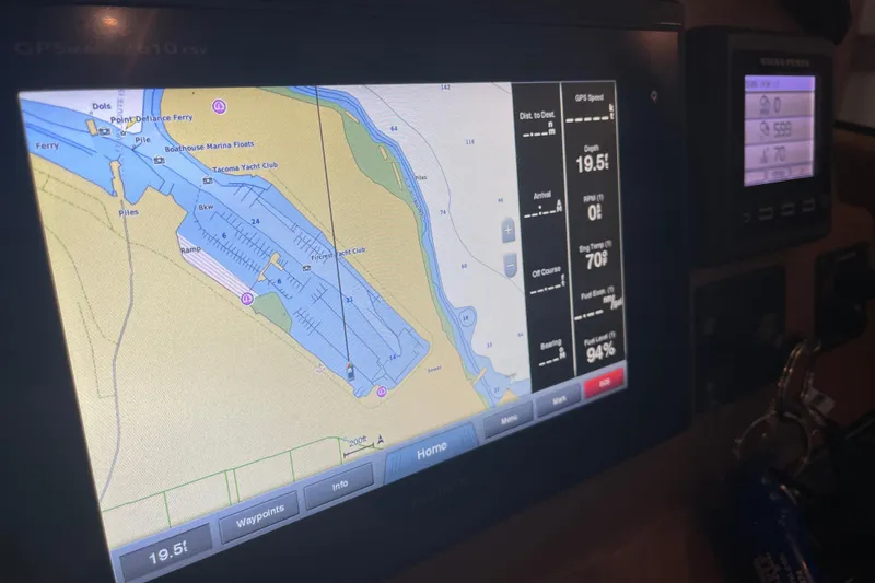 Slide: The Image of 2016 Cutwater C-24 helm with steering wheel, radio, and control panel. - 15