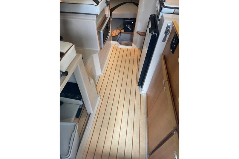 Slide: The Image of 2016 Cutwater C-24 helm with Garmin GPS, wooden steering wheel, and control panel. - 17