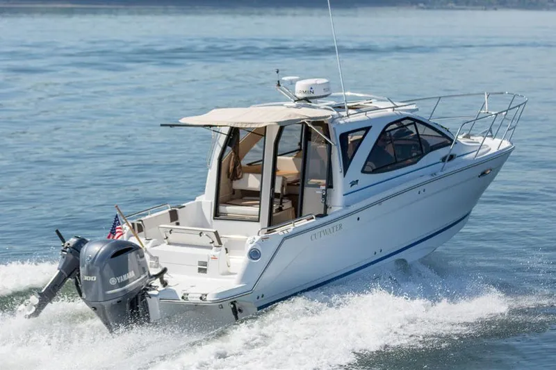 Slide: The Image of 2016 Cutwater C-24 boat docked in a covered marina with Garmin equipment. - 2