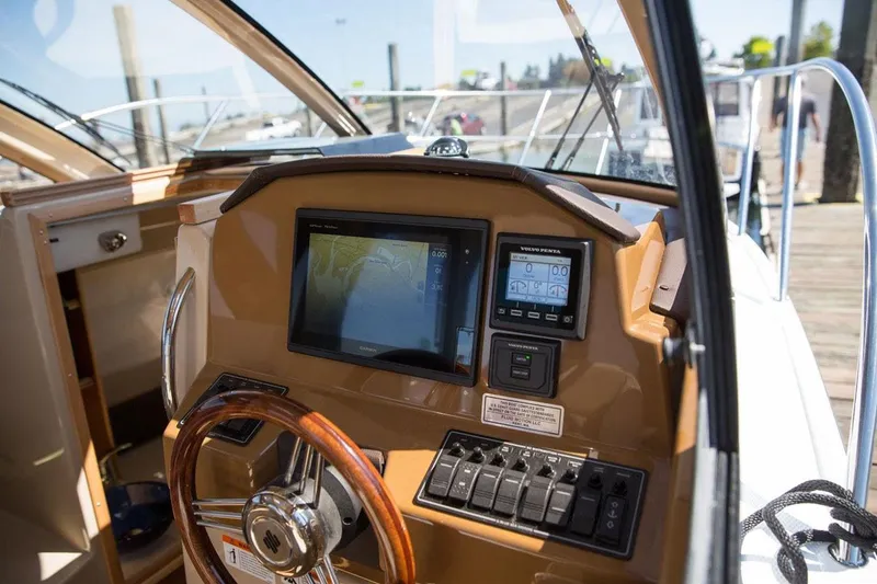 Slide: The Image of Interior of 2016 Cutwater C-24 boat with wood flooring and compact kitchen area. - 6