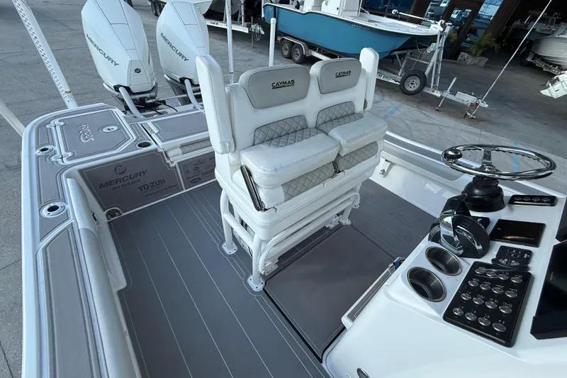 Slide: The Image of 2022 Caymas 28 HB Twin boat interior with cushioned seating and dual engines. - 13