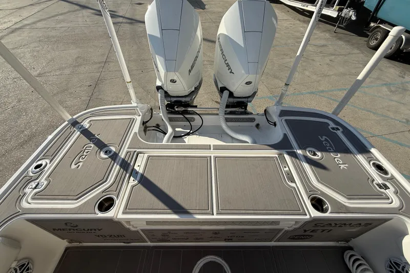 Slide: The Image of 2022 Caymas 28 HB Twin boat interior with Yeti cooler and storage compartment. - 17