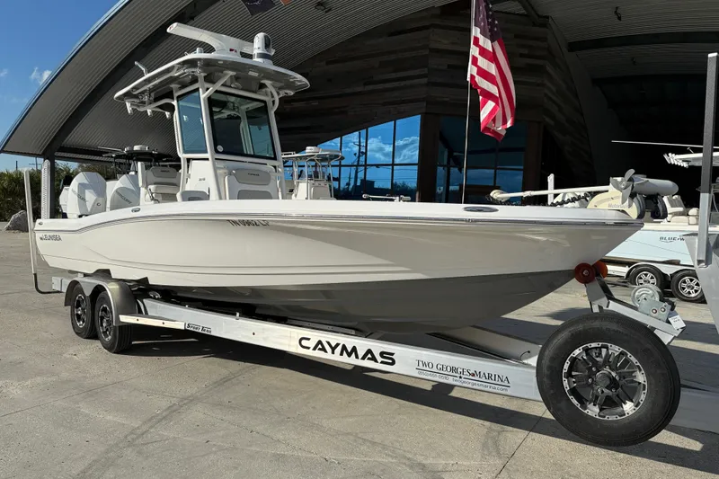Slide: The Image of 2022 Caymas 28 HB Twin boat on trailer, viewed from below, sunny day. - 2
