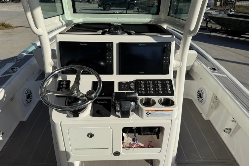 Slide: The Image of Control panel of 2022 Caymas 28 HB Twin boat with dual Raymarine displays. - 20