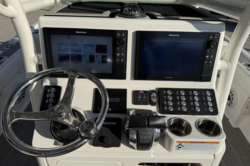 Slide: The Image of Raymarine display on 2022 Caymas 28 HB Twin, showing navigation and fishfinder features. - 22