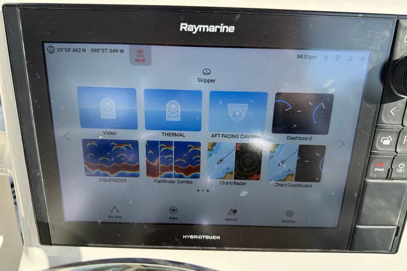 Slide: The Image of Control panel of 2022 Caymas 28 HB Twin boat with Raymarine displays and controls. - 23
