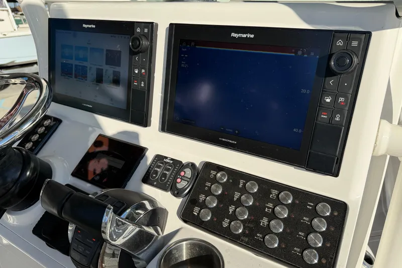 Slide: The Image of Interior of 2022 Caymas 28 HB Twin boat with control panel and fire extinguisher. - 24