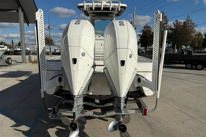 Slide: The Image of 2022 Caymas 28 HB Twin boat with dual Mercury engines on a trailer. - 6