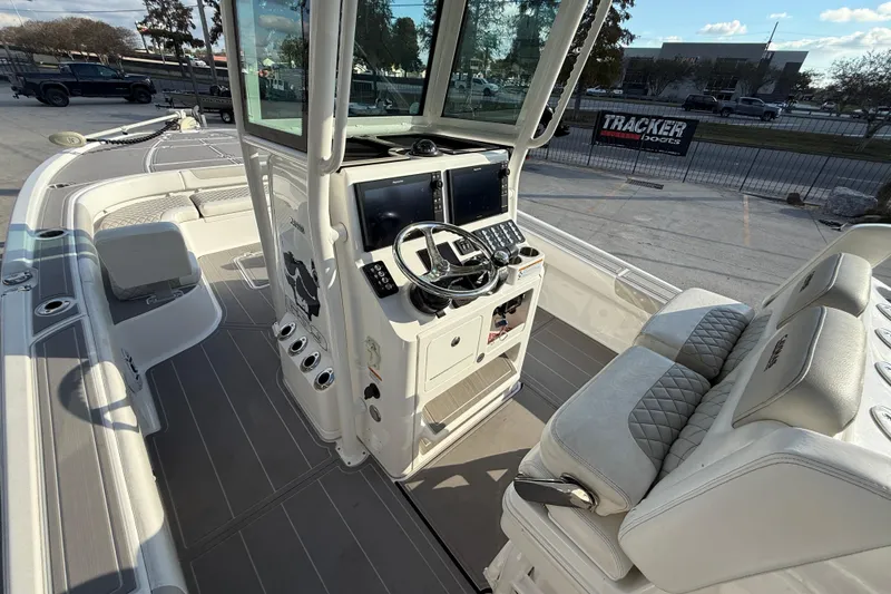 Slide: The Image of 2022 Caymas 28 HB Twin boat interior with cushioned seating and steering console. - 9
