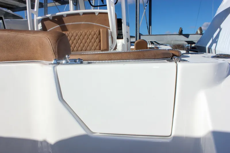 Slide: The Image of 2026 Sea Hunt Ultra 285 SE boat with brown seating and white exterior. - 13