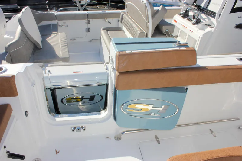 Slide: The Image of 2026 Sea Hunt Ultra 285 SE boat interior with seating and control panel. - 19