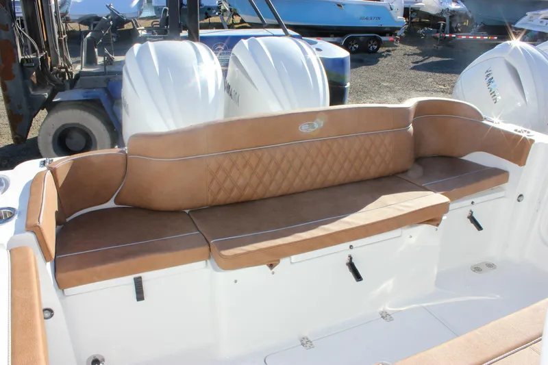 Slide: The Image of 2026 Sea Hunt Ultra 285 SE boat with tan cushioned seating and dual Yamaha engines. - 21